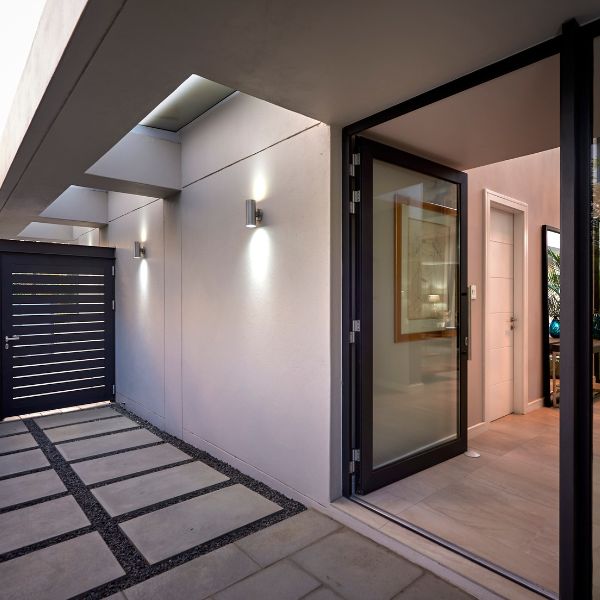 Flamed Granite Cobble-Flamed Granite Flagstone -Bullnose Range2 Entrance paved with Creative Stone cobblestones leading to an elegant luxury estate